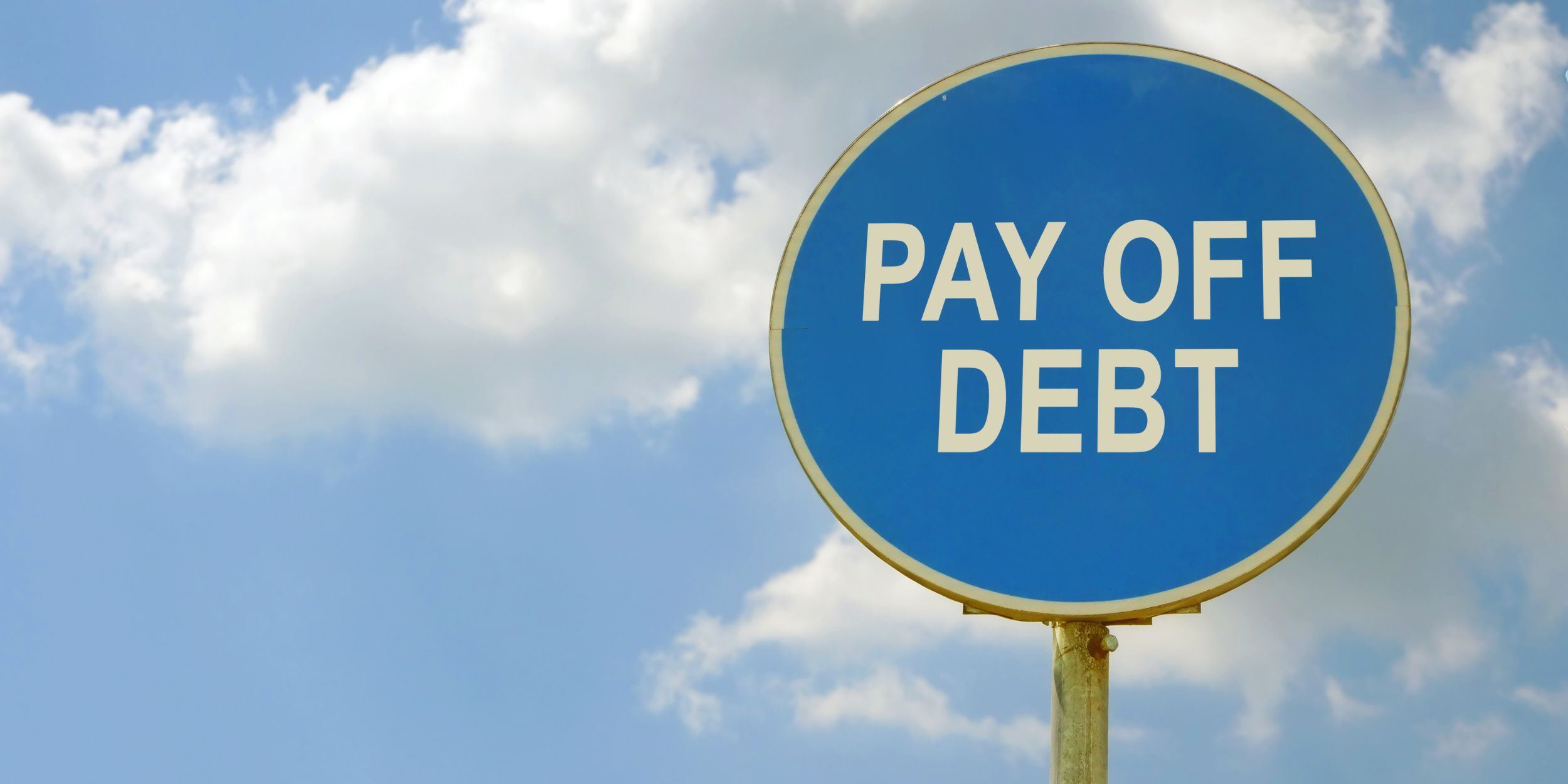 Road sign pay off debt and blue sky.